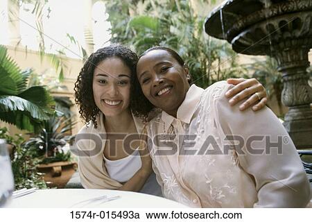 Portrait of a mother and daughter smiling in a restaurant View Large Photo Image Stock Image - Portrait of a mother and daughter smiling in a restaurant. Fotosearch