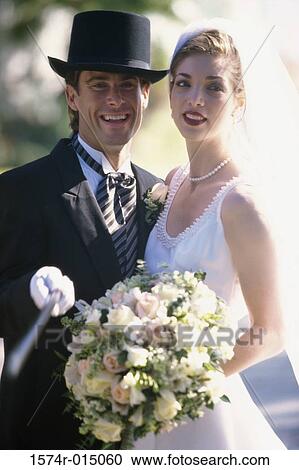 Portrait of a newlywed couple smiling View Large Photo Image Stock Image - Portrait of a newlywed couple smiling. Fotosearch