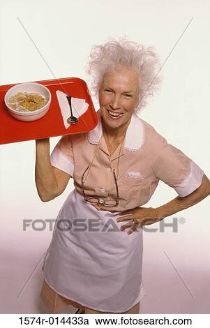 Portrait of a senior woman carrying a tray of food View Large Photo Image Stock Image - Portrait of a senior woman carrying a tray of food. Fotosearch