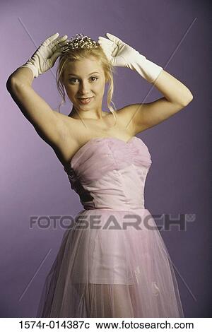 Portrait of a teenage girl holding a tiara View Large Photo Image Stock Image - Portrait of a teenage girl holding a tiara. Fotosearch