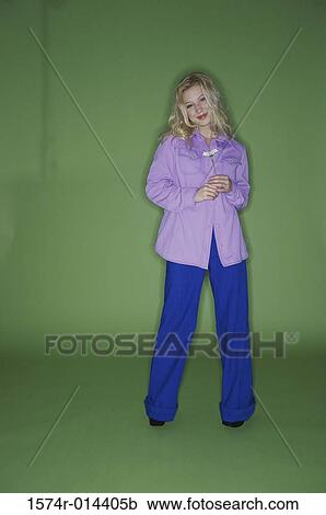 Stock Image - Portrait of a teenage girl holding a flower. Fotosearch