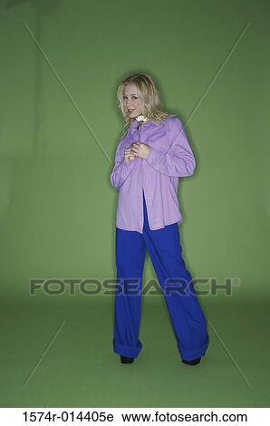 Stock Image - Portrait of a teenage girl holding a flower. Fotosearch
