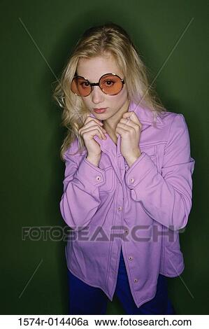 Portrait of a teenage girl holding her shirt collar View Large Photo Image Stock Image - Portrait of a teenage girl holding her shirt collar. Fotosearch
