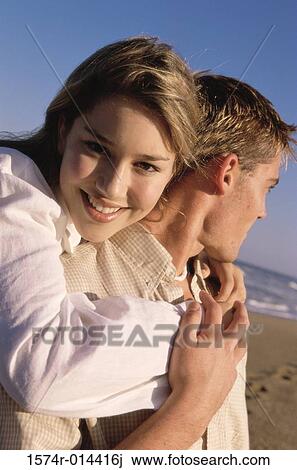 Stock Image - Portrait of a teenage girl hugging a young man. Fotosearch