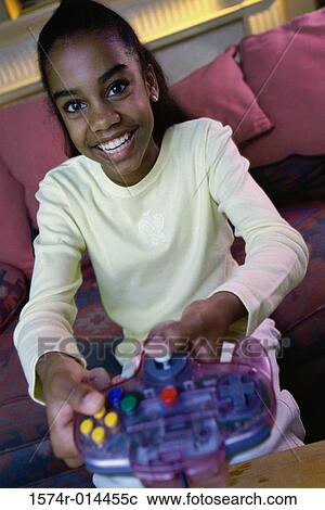Portrait of a teenage girl playing video games View Large Photo Image Stock Image - Portrait of a teenage girl playing video games. Fotosearch