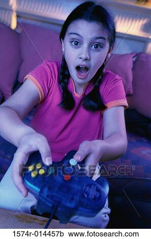 Portrait of a teenage girl playing video games View Large Photo Image Stock Image - Portrait of a teenage girl playing video games. Fotosearch