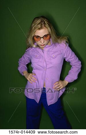Stock Photo - Portrait of a teenage girl standing with her arms akimbo. Fotosearch
