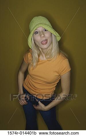 Stock Image - Portrait of a teenage girl sticking her tongue out. Fotosearch