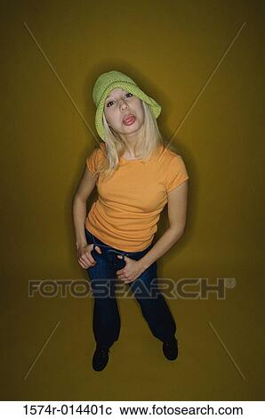 Stock Image - Portrait of a teenage girl sticking her tongue out. Fotosearch