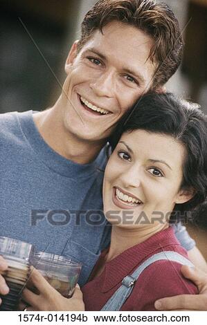 Portrait of a young couple holding drinks View Large Photo Image Stock Image - Portrait of a young couple holding drinks. Fotosearch