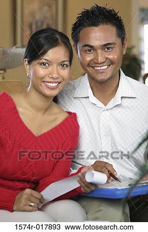 Stock Image - Portrait of a young couple smiling. Fotosearch