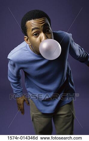 Portrait of a young man blowing a bubble View Large Photo Image Stock Image - Portrait of a young man blowing a bubble. Fotosearch