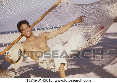 Portrait of a young man lying in a hammock View Large Photo Image Stock Image - Portrait of a young man lying in a hammock. Fotosearch