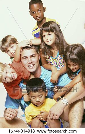 Portrait of a young man playing with children View Large Photo Image Stock Photo - Portrait of a young man playing with children. Fotosearch