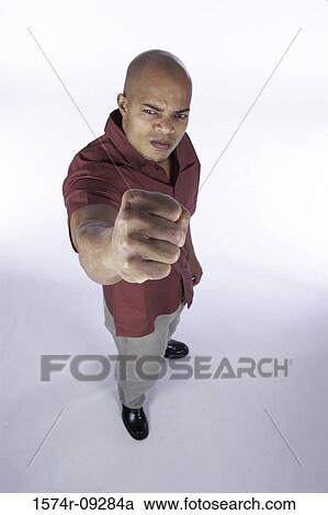 Portrait of a young man showing his fist View Large Photo Image Stock Image - Portrait of a young man showing his fist. Fotosearch