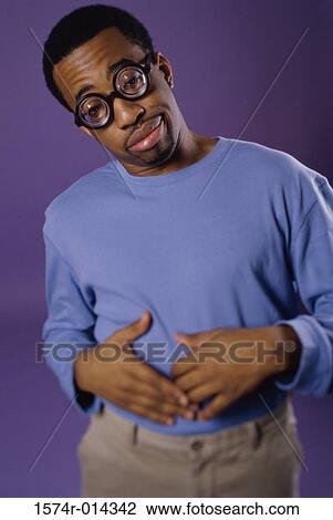 Stock Image - Portrait of a young man with an upset stomach. Fotosearch