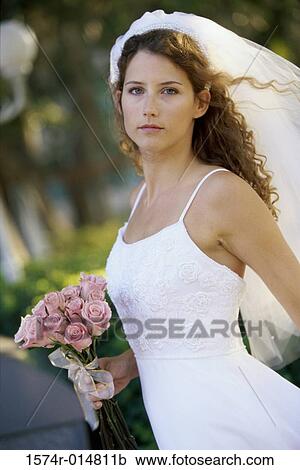 Portrait of a young woman in a wedding dress View Large Photo Image Stock Image - Portrait of a young woman in a wedding dress. Fotosearch