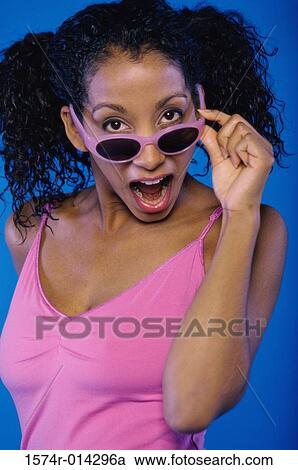 Portrait of a young woman looking surprised View Large Photo Image Stock Image - Portrait of a young woman looking surprised. Fotosearch