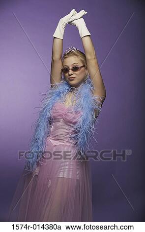 Portrait of a young woman standing with her arms raised View Large Photo Image Stock Image - Portrait of a young woman standing with her arms raised. Fotosearch