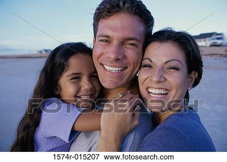 Portrait of parents and their daughter smiling on the beach View Large Photo Image Stock Photo - Portrait of parents and their daughter smiling on the beach. Fotosearch