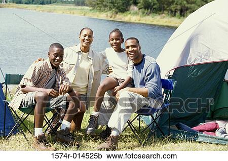 Portrait of parents sitting at a campsite with their son and daughter View Large Photo Image Stock Image - Portrait of parents sitting at a campsite with their son and daughter. Fotosearch