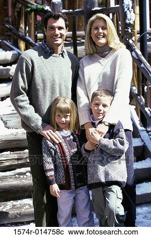 Stock Image - Portrait of parents standing with their son and daughter. Fotosearch