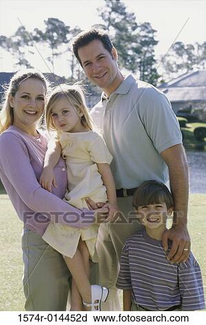 Stock Image - Portrait of parents with their son and daughter smiling. Fotosearch
