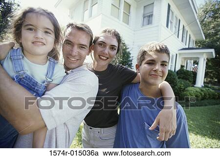 Stock Image - Portrait of parents with their son and daughter smiling. Fotosearch