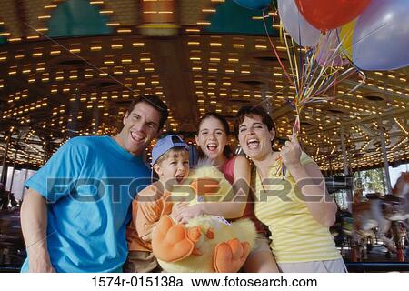 Portrait of parents with their son and daughter in an amusement park View Large Photo Image Stock Image - Portrait of parents with their son and daughter in an amusement park. Fotosearch