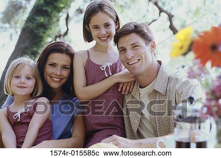 Portrait of parents with their two daughters smiling View Large Photo Image Stock Image - Portrait of parents with their two daughters smiling. Fotosearch