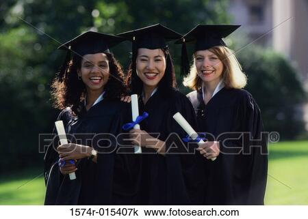 Portrait of three young women wearing graduation gowns and holding diplomas View Large Photo Image Stock Image - Portrait of three young women wearing graduation gowns and holding diplomas. Fotosearch