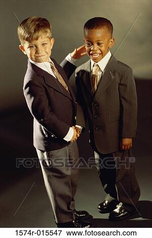 Portrait of two boys dressed as businessmen shaking hands View Large Photo Image Stock Photo - Portrait of two boys dressed as businessmen shaking hands. Fotosearch