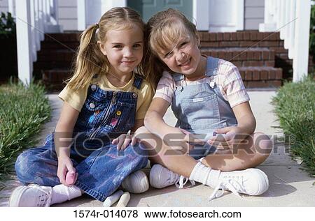 Portrait of two girls sitting together View Large Photo Image Stock Photo - Portrait of two girls sitting together. Fotosearch