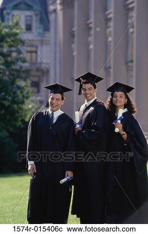 Stock Image - Portrait of two male graduates with a female graduate holding diplomas. Fotosearch