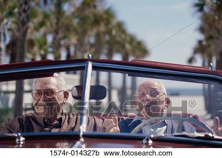 Stock Image - Portrait of two senior men sitting in a convertible car. Fotosearch