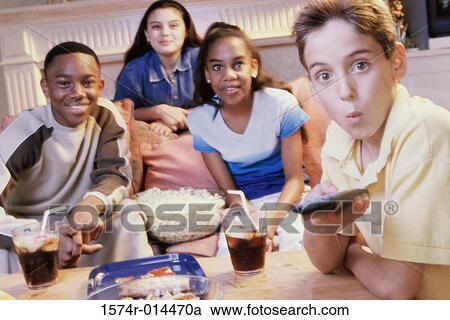 Portrait of two teenage boys and two teenage girls watching television together View Large Photo Image Stock Image - Portrait of two teenage boys and two teenage girls watching television together. Fotosearch