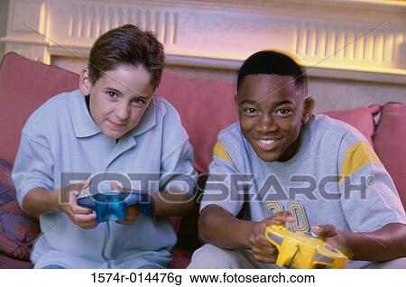 Portrait of two teenage boys playing video games View Large Photo Image Stock Image - Portrait of two teenage boys playing video games. Fotosearch