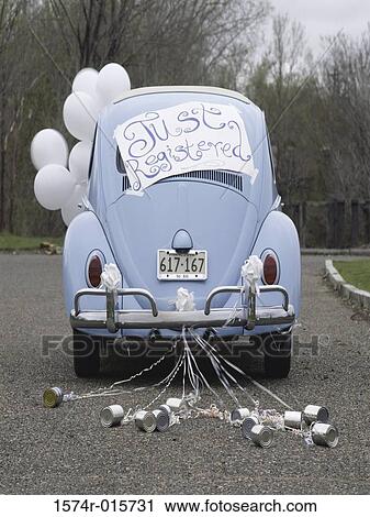 Stock Image - Rear view of a car with tin cans and balloons. Fotosearch