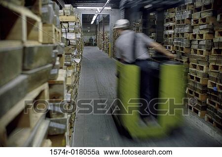 Rear view of a man driving a forklift View Large Photo Image Stock Image - Rear view of a man driving a forklift. Fotosearch