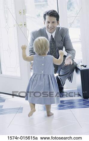 Rear view of girl greeting her father at the front door View Large Photo Image Stock Image - Rear view of girl greeting her father at the front door. Fotosearch