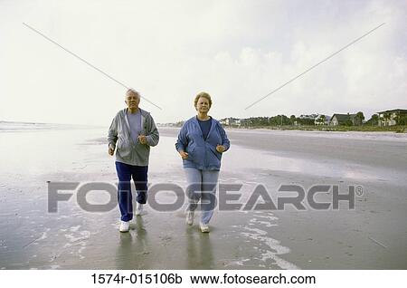 Senior couple jogging on the beach View Large Photo Image Stock Image - Senior couple jogging on the beach. Fotosearch