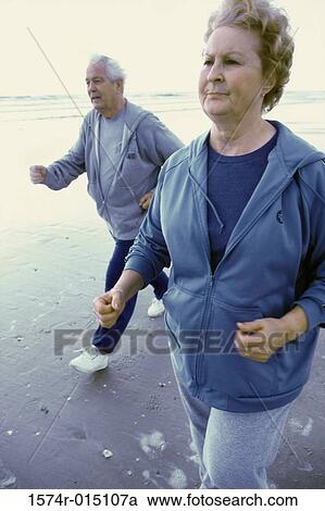 Senior couple jogging on the beach View Large Photo Image Stock Image - Senior couple jogging on the beach. Fotosearch