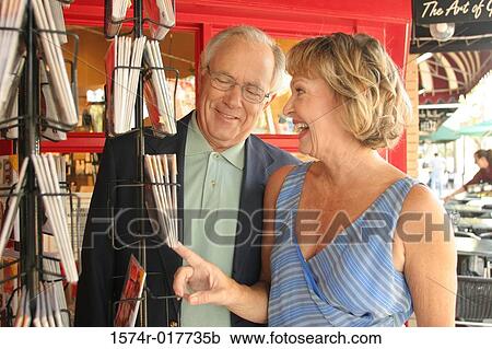 Senior couple looking at books in a bookstore View Large Photo Image Stock Image - Senior couple looking at books in a bookstore. Fotosearch