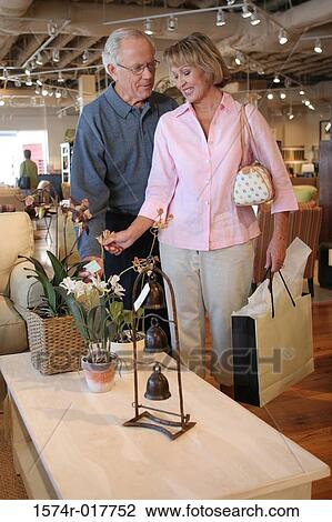 Senior couple looking at potted plants in a store View Large Photo Image Stock Image - Senior couple looking at potted plants in a store. Fotosearch