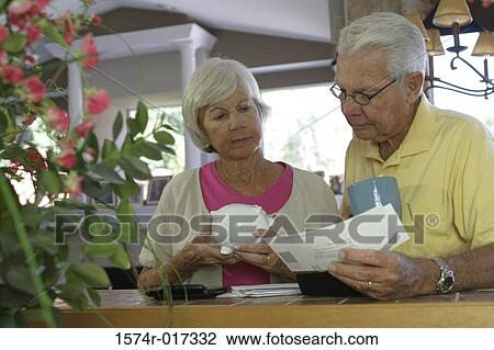 Senior couple reading a bill View Large Photo Image Stock Image - Senior couple reading a bill. Fotosearch