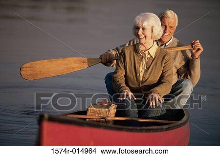 Picture - Senior couple rowing a boat. Fotosearch