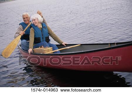 Senior couple rowing a boat View Large Photo Image Stock Image - Senior couple rowing a boat. Fotosearch
