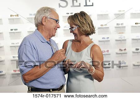 Senior couple selecting sunglasses in a store View Large Photo Image Stock Image - Senior couple selecting sunglasses in a store. Fotosearch