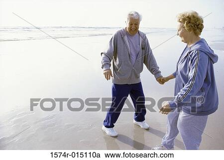 Senior couple standing on the beach View Large Photo Image Stock Image - Senior couple standing on the beach. Fotosearch