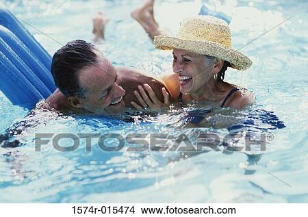 Senior couple swimming in a swimming pool View Large Photo Image Picture - Senior couple swimming in a swimming pool. Fotosearch